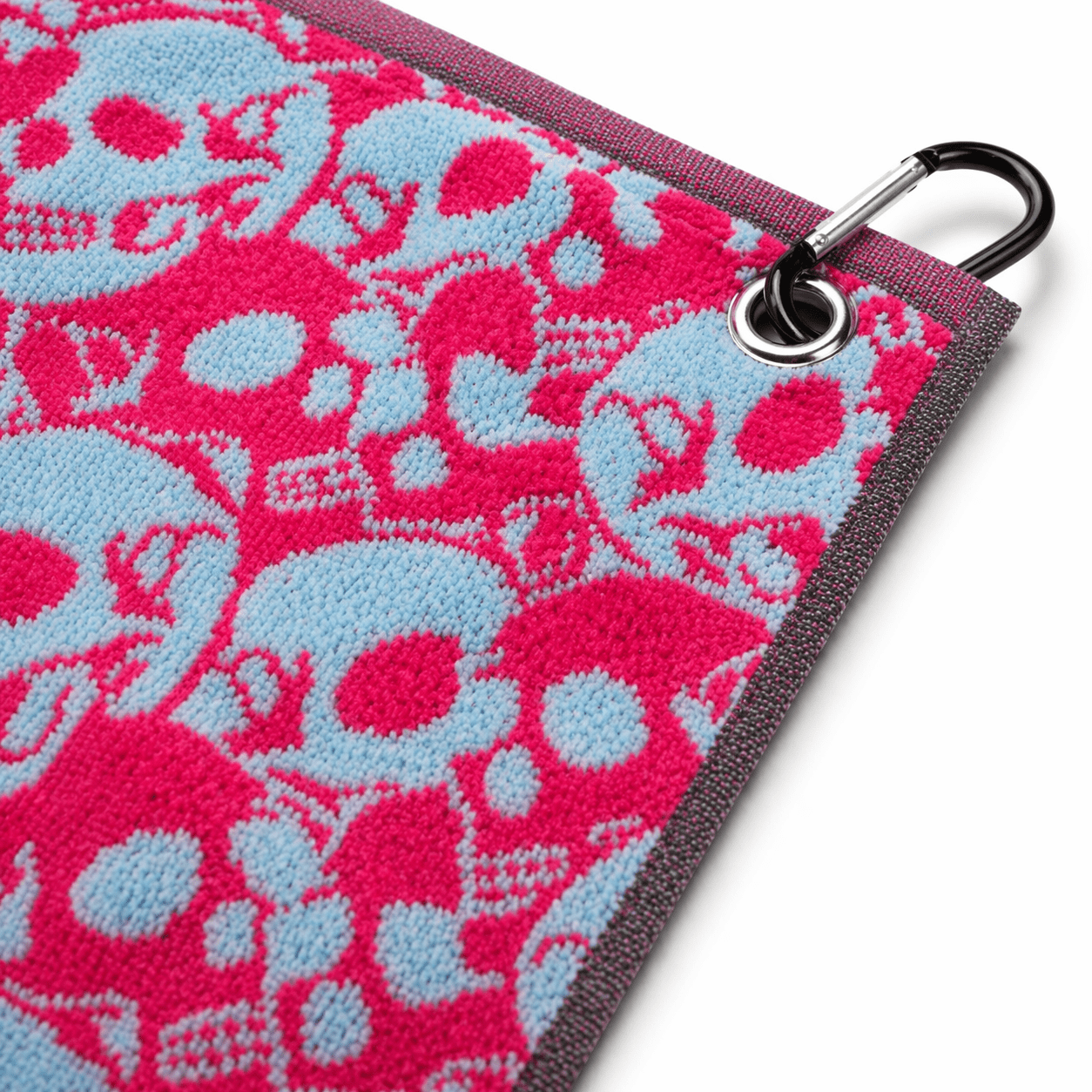 Microfiber cleaning cloth with pink and blue skull pattern and carabiner clip on a white background