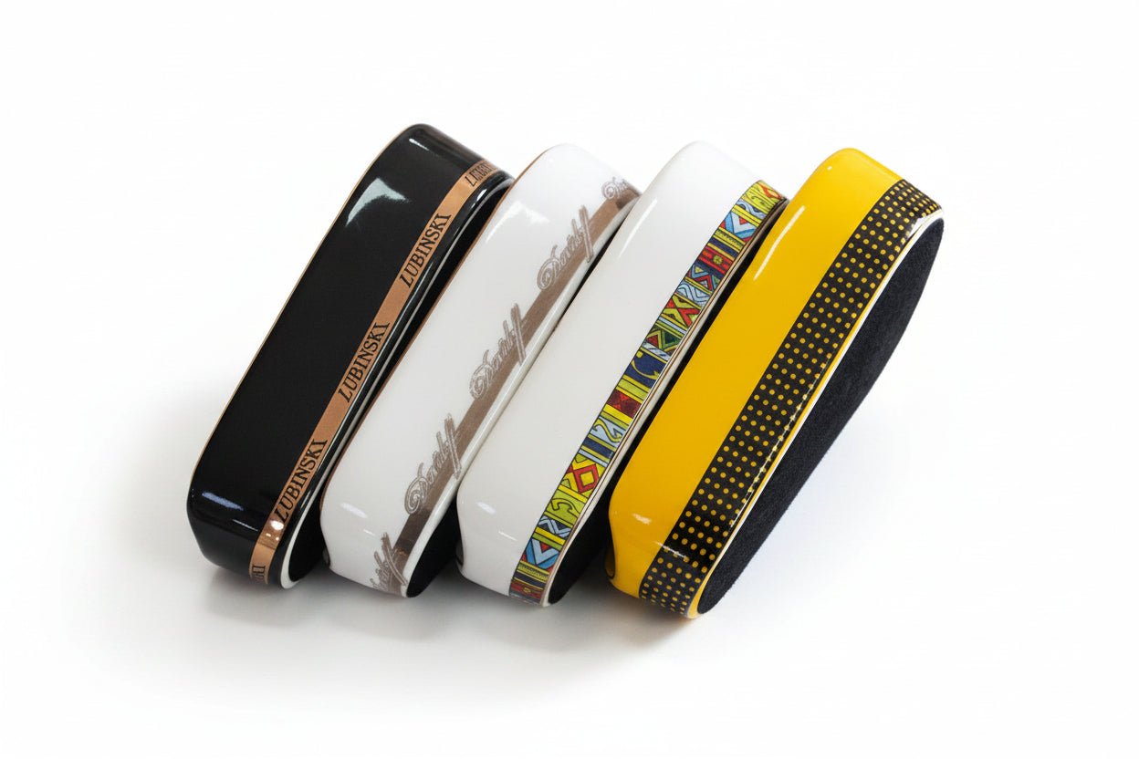 Four decorative items with different designs on a black textured surface