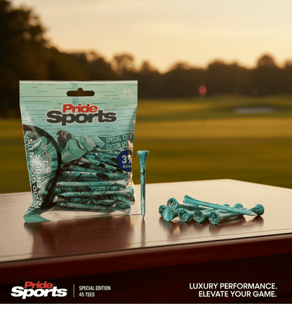 Teal PrideSports golf tees package with paint-splatter design on table, several green tees arranged and one upright with blurred golf course background