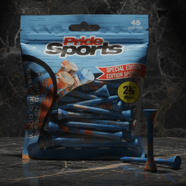 Blue PrideSports golf tees package with paint-splatter design on dark marble surface, scattered blue and orange tees in front