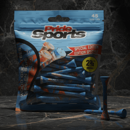 Blue PrideSports golf tees package with paint-splatter design on dark marble surface, scattered blue and orange tees in front