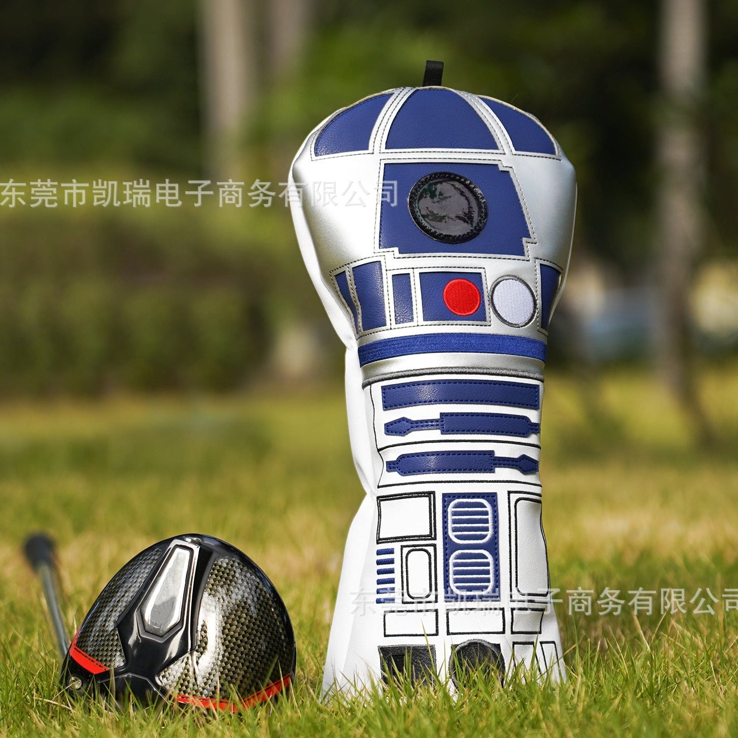 Golf club head cover shaped like a robot on grass
