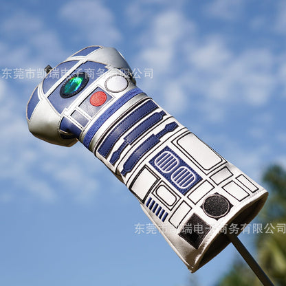 Toy robot resembling R2-D2 against a blue sky background