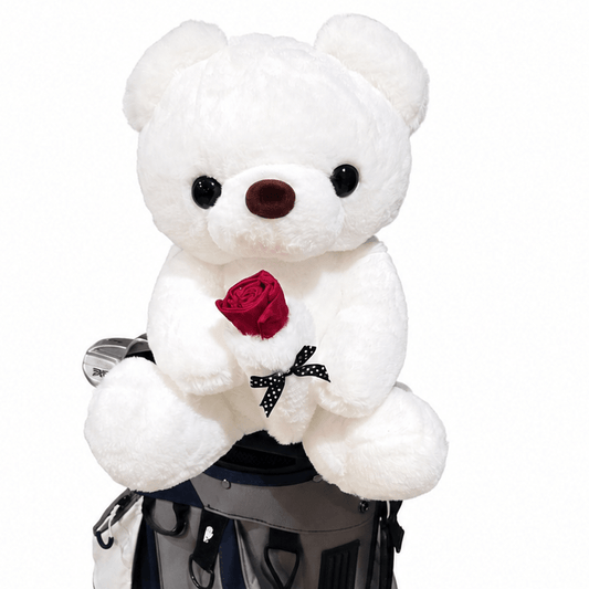 White teddy bear with a red rose in a golf bag on a white background