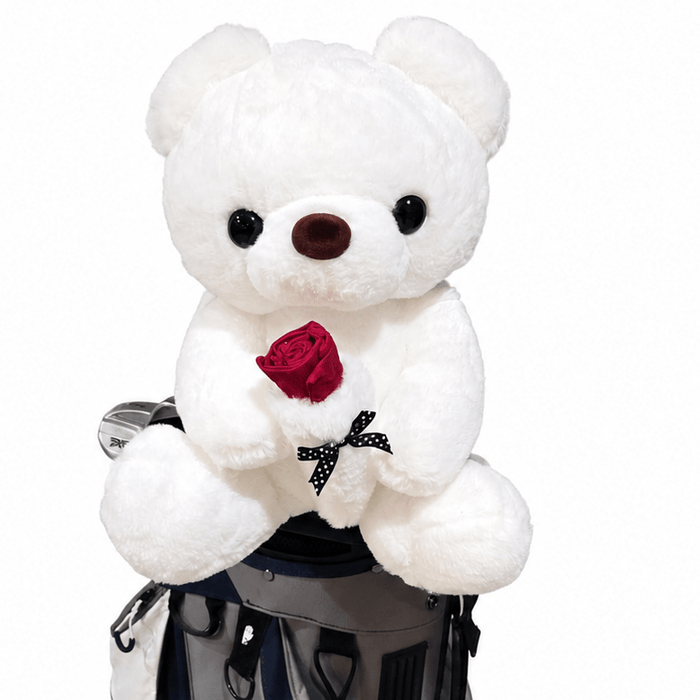 White teddy bear with a red rose in a golf bag on a white background
