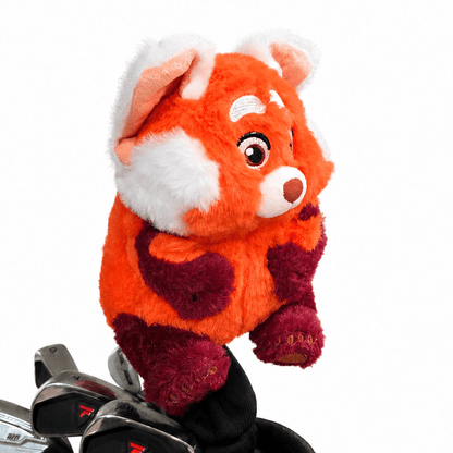 Plush red pand head coveron top of a golf club bag with golf clubs inside