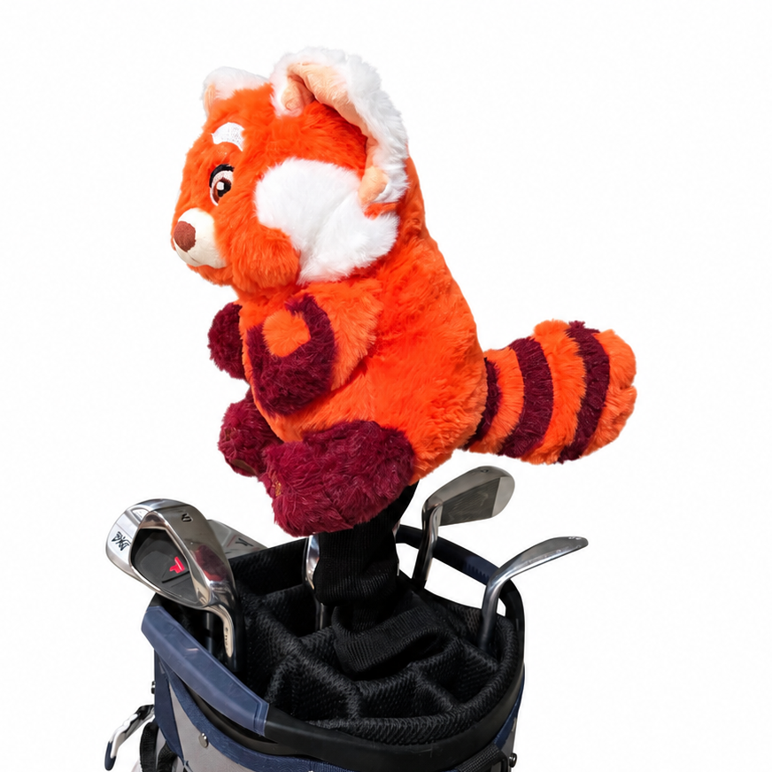 Plush toy red panda in a golf bag with golf clubs on a white background