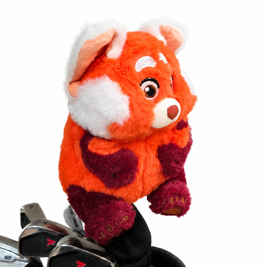 Plush red pand head coveron top of a golf club bag with golf clubs inside