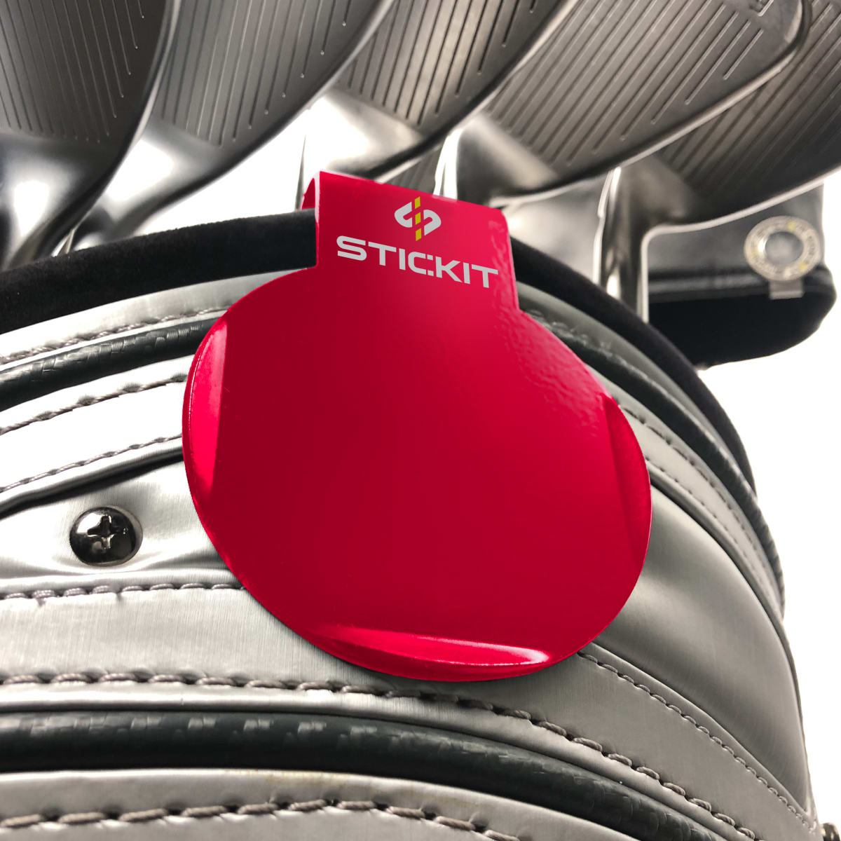 Red STICKIT landing pad clipped to a golf bag