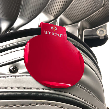 Red STICKIT landing pad clipped to a golf bag