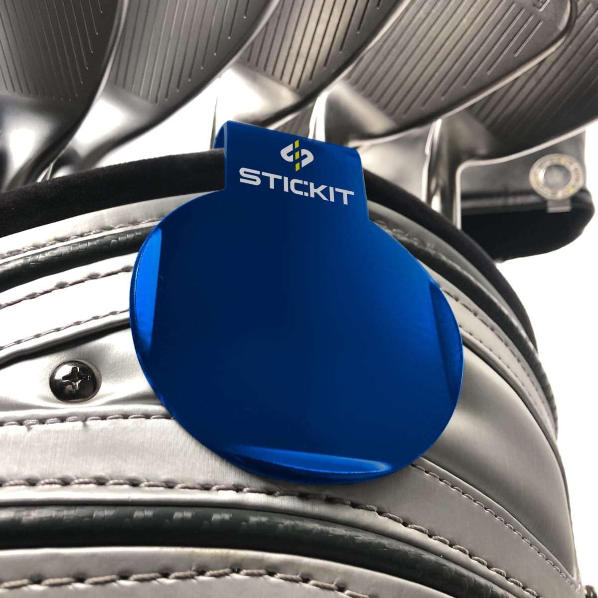Blue STICKIT landing pad clipped to a golf bag