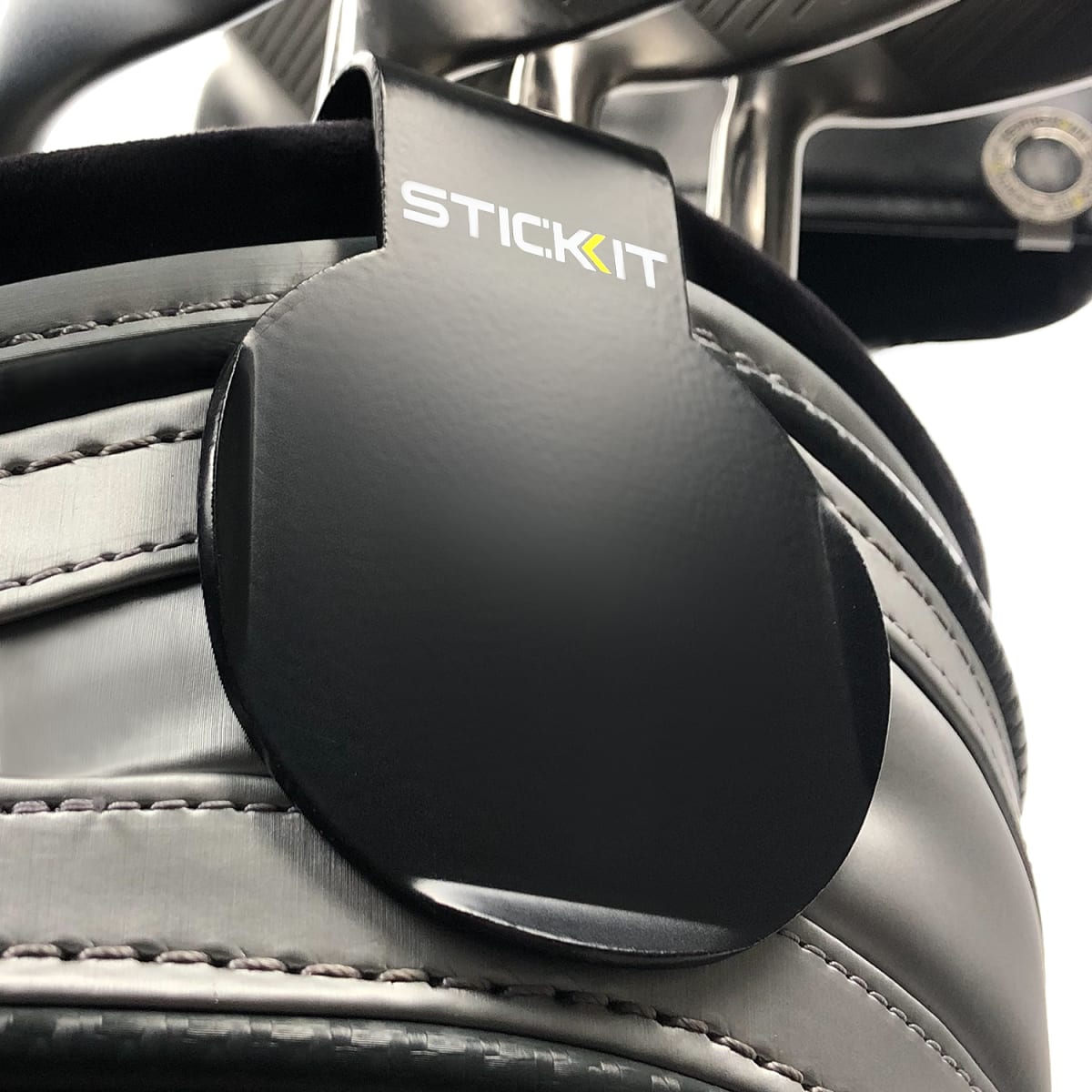 Black STICKIT landing pad clipped to a golf bag