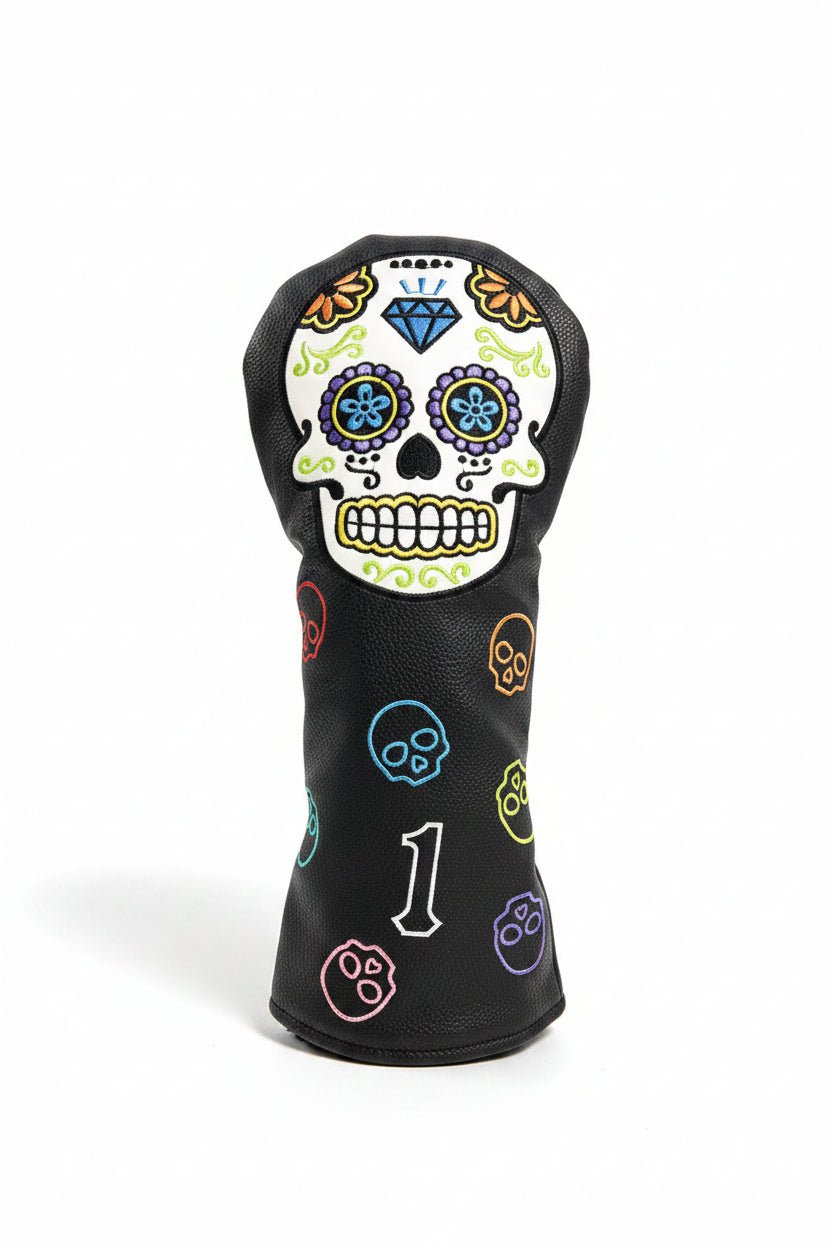 Golf club head cover with colorful skull design on grass