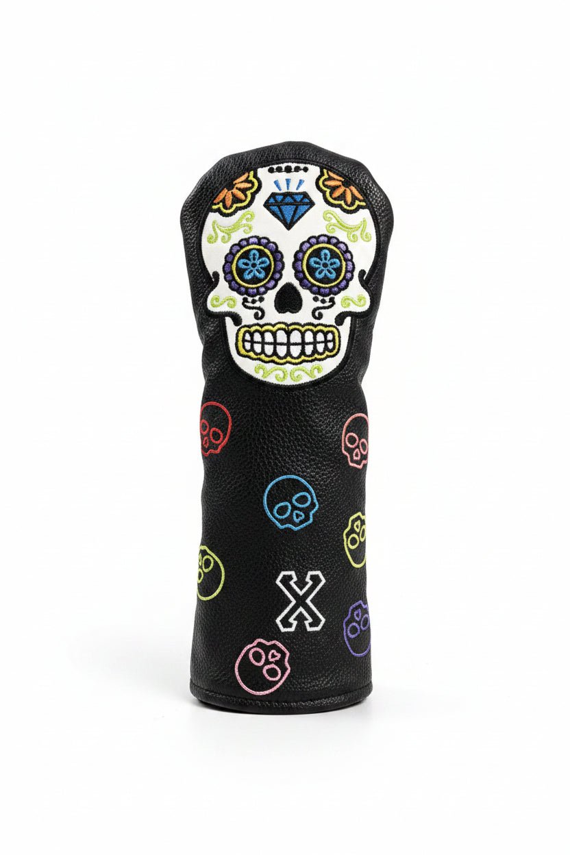 Golf club head cover with colorful skull design on grass