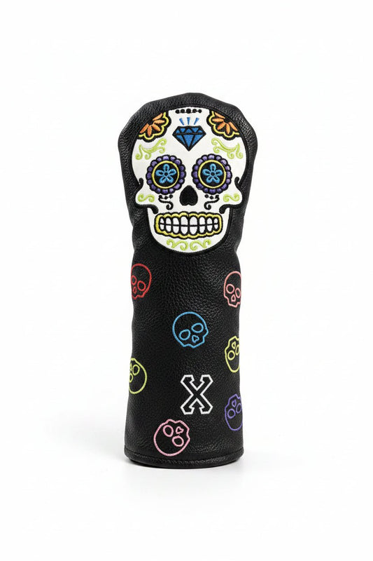 Golf club head cover with colorful skull design on grass