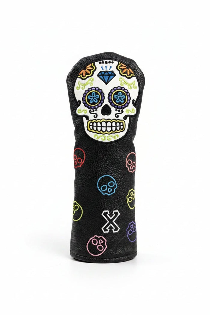 Golf club head cover with colorful skull design on grass
