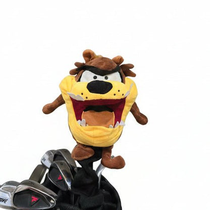 Plush toy resembling a cartoon character next to golf clubs in a storage room.