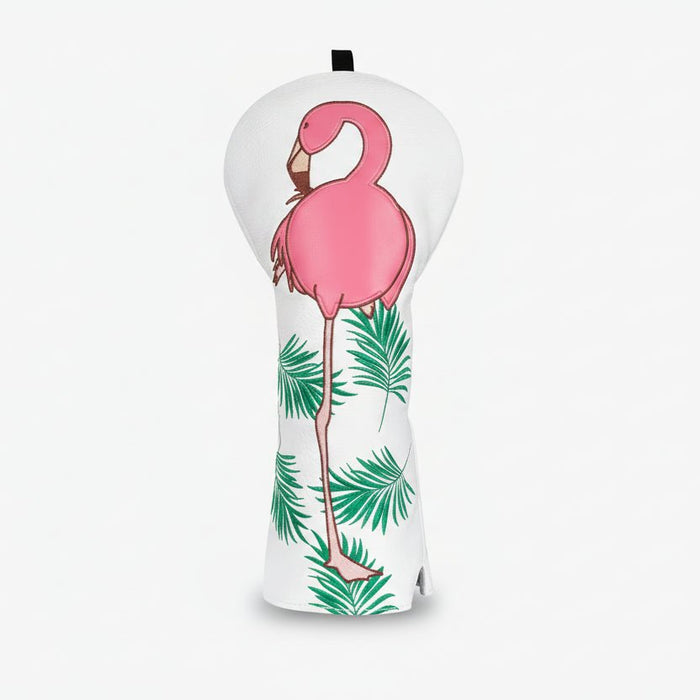 Heart-shaped pillow with a pink flamingo and green leaves design on a white background