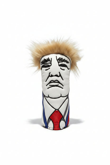 Colorful golf club head cover on a marble surface with a bottle of oil in the background.