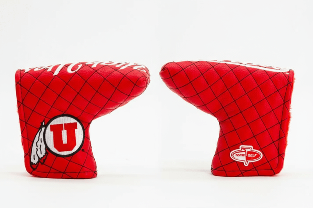 Two red golf club covers with logos on a white background